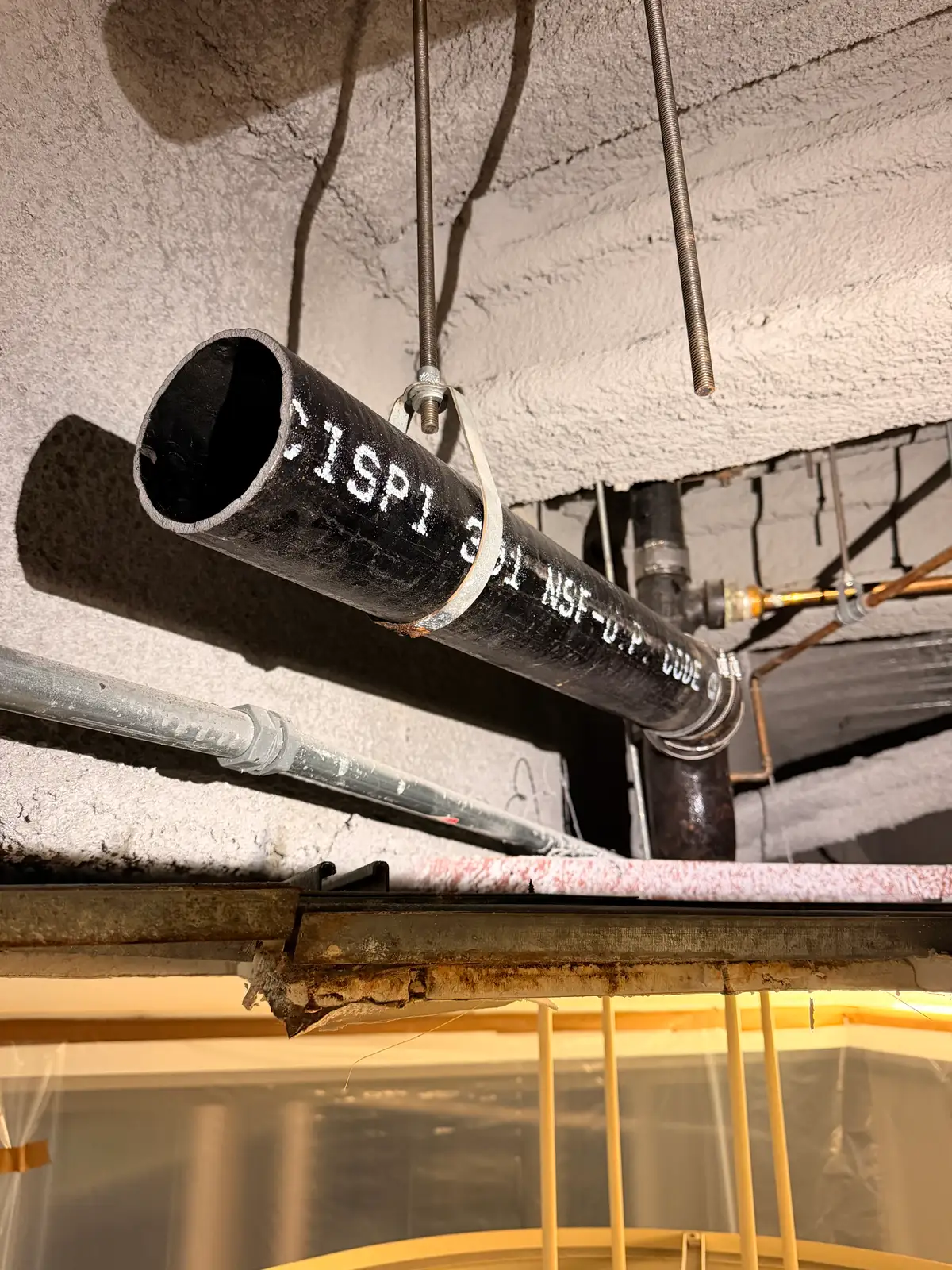 Mainline Plumbing new code-compliant cast iron drain pipe installed during an overnight commercial replacement at Providence St. Joseph Hospital